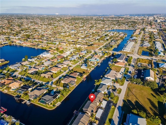 birds eye view of property with a water view and a residential view