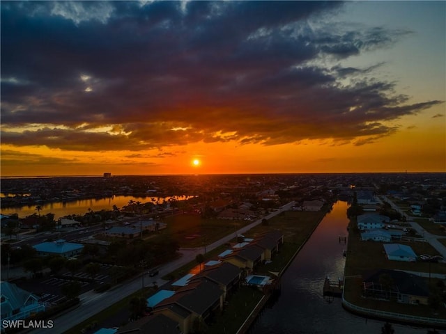 aerial view at dusk with a water view