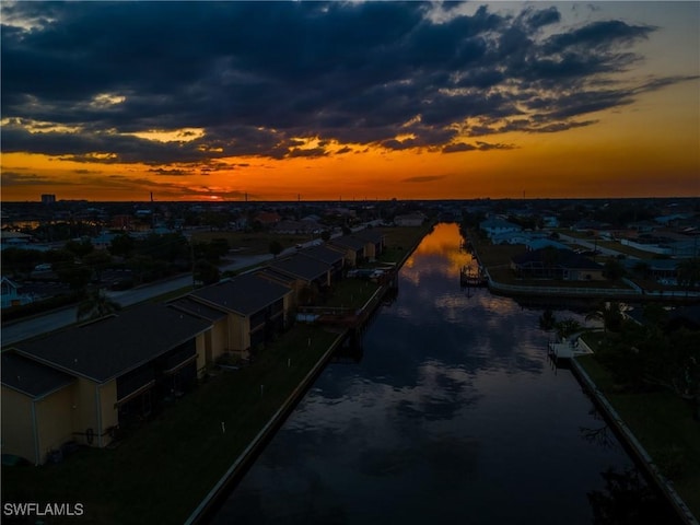 aerial view at dusk with a water view