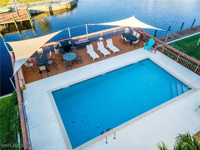 view of swimming pool featuring a deck with water view