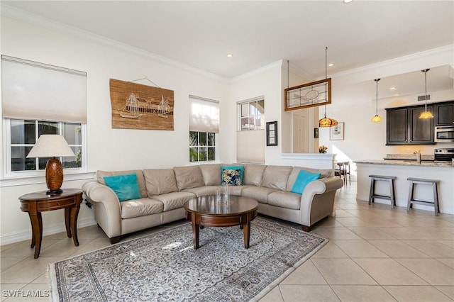 tiled living room with sink and ornamental molding