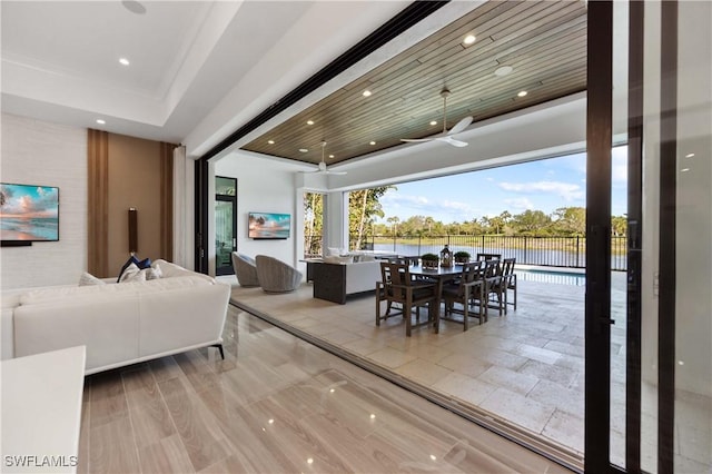 dining room featuring ceiling fan, a raised ceiling, and wooden ceiling