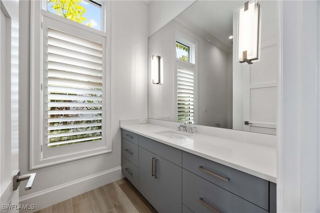 bathroom with vanity and ornamental molding