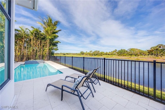 view of swimming pool with a water view and a patio