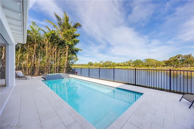 view of swimming pool featuring a water view and a patio