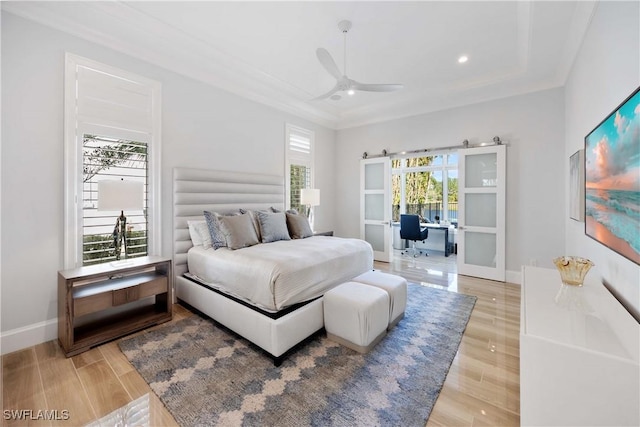 bedroom with light hardwood / wood-style flooring, ceiling fan, and ornamental molding