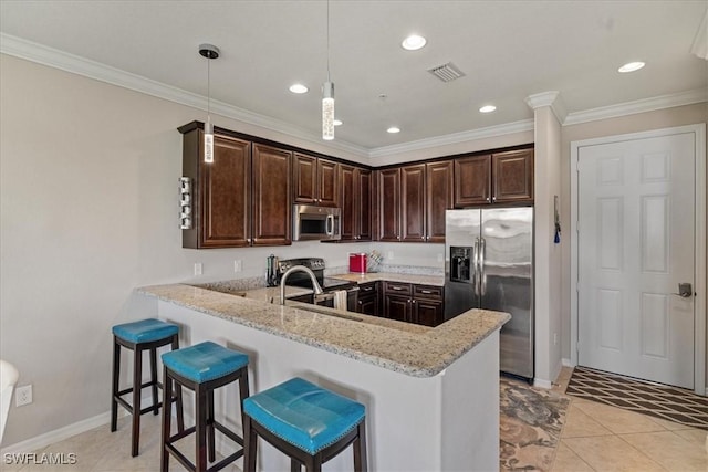 kitchen with hanging light fixtures, stainless steel appliances, light stone counters, kitchen peninsula, and light tile patterned flooring