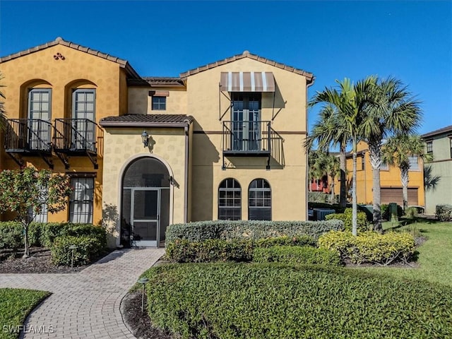 mediterranean / spanish-style house with a balcony