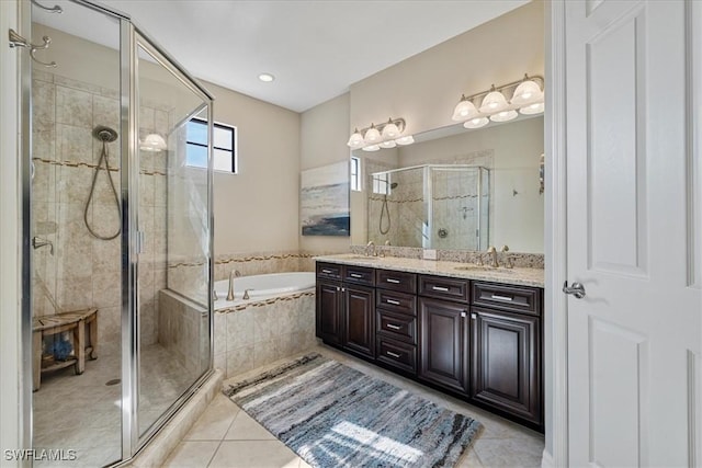 bathroom featuring tile patterned flooring, shower with separate bathtub, and vanity