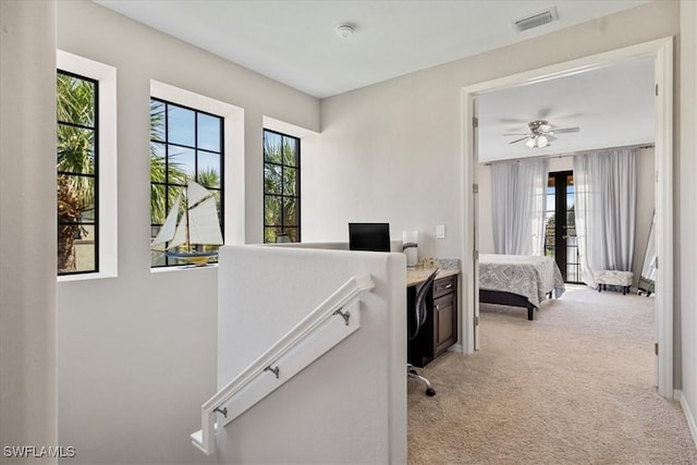 office with light colored carpet and ceiling fan