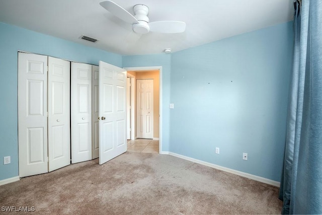 unfurnished bedroom with baseboards, carpet, visible vents, and a closet