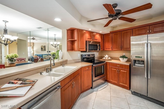 kitchen with hanging light fixtures, appliances with stainless steel finishes, a sink, and recessed lighting