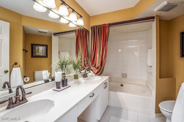 full bathroom featuring toilet, visible vents, a sink, and tile patterned floors