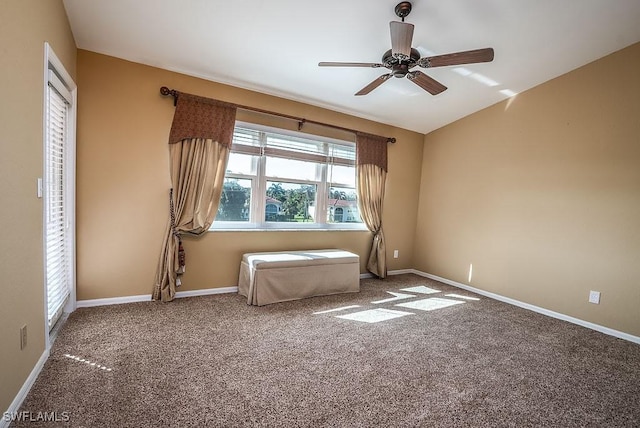 unfurnished room with carpet, vaulted ceiling, ceiling fan, and baseboards