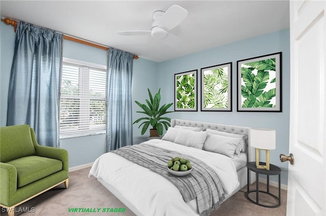 carpeted bedroom with baseboards and a ceiling fan