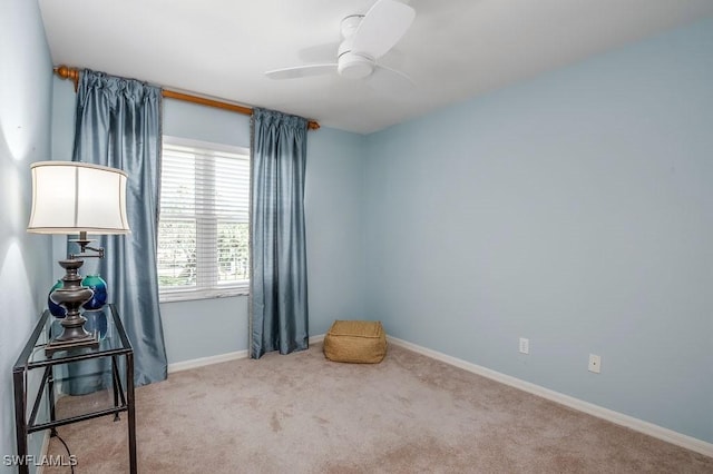 misc room with carpet floors, a ceiling fan, and baseboards