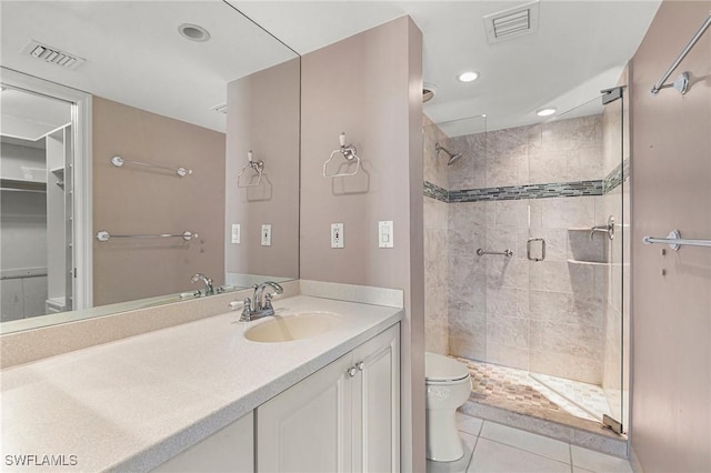 full bathroom featuring a stall shower, visible vents, toilet, tile patterned floors, and vanity