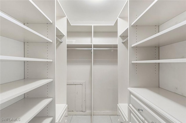 spacious closet with tile patterned floors