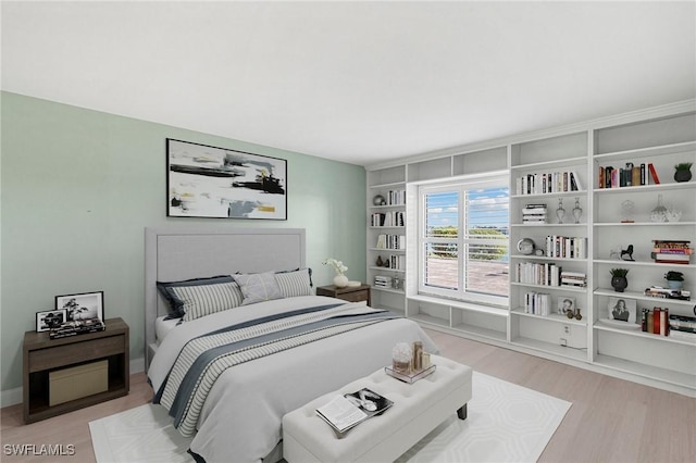 bedroom featuring baseboards and light wood-style floors