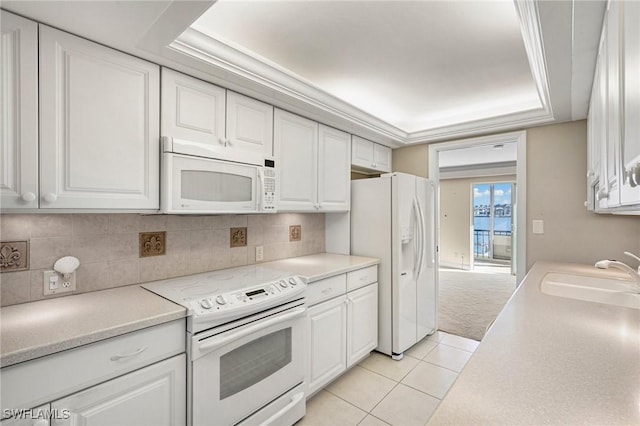 kitchen featuring white cabinets, white appliances, decorative backsplash, and a sink