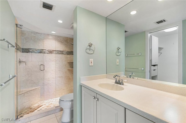 full bathroom featuring visible vents, a shower stall, toilet, and vanity