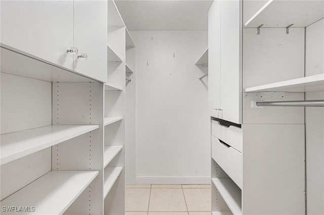 spacious closet featuring light tile patterned floors