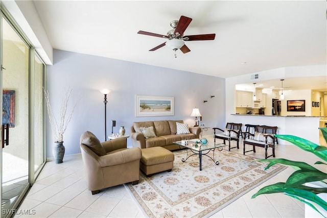 tiled living room with ceiling fan