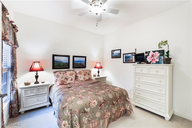 bedroom featuring ceiling fan and light carpet