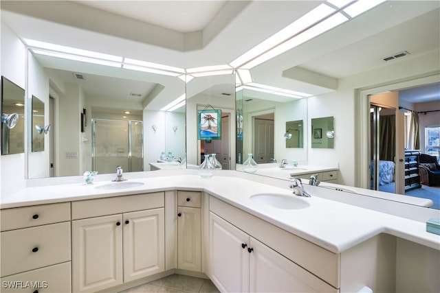 bathroom featuring tile patterned flooring, vanity, and an enclosed shower