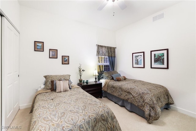 carpeted bedroom featuring ceiling fan and a closet