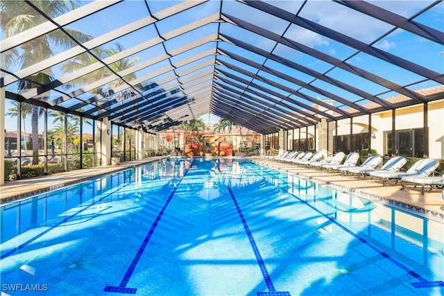 view of swimming pool featuring a lanai