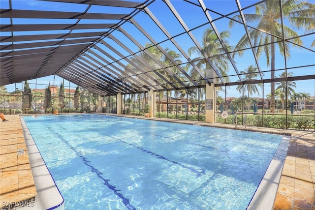 view of pool featuring glass enclosure