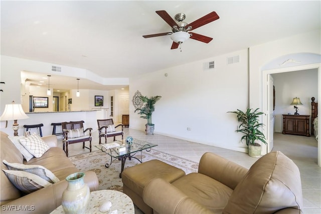 tiled living room featuring ceiling fan