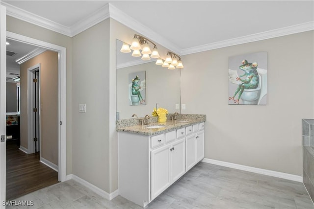 bathroom with crown molding and vanity