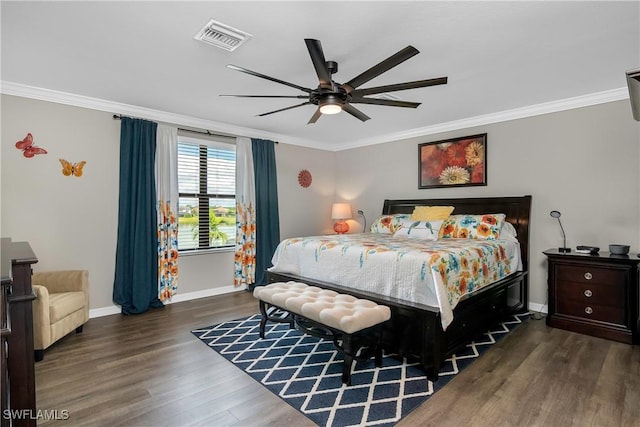 bedroom featuring ceiling fan, dark hardwood / wood-style flooring, and crown molding