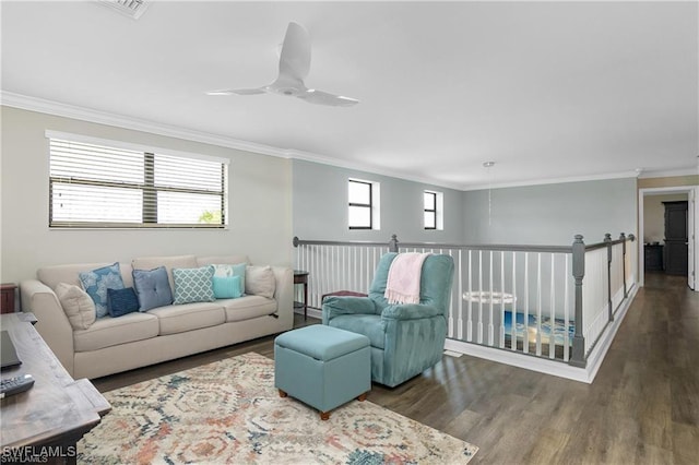 living room featuring ceiling fan, ornamental molding, a wealth of natural light, and dark hardwood / wood-style flooring