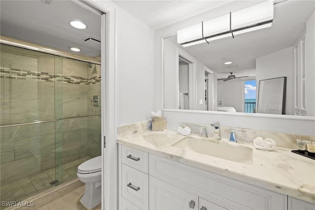 full bathroom featuring toilet, a shower stall, connected bathroom, and vanity