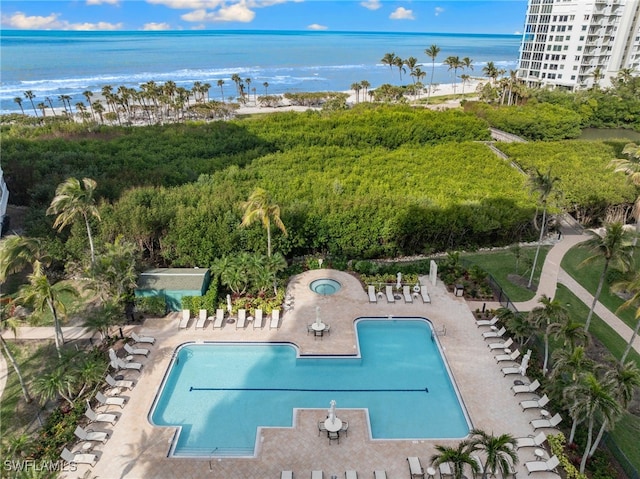 pool with a water view and a patio area