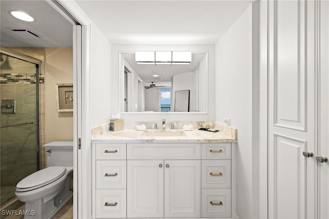 bathroom with toilet, a stall shower, visible vents, and vanity