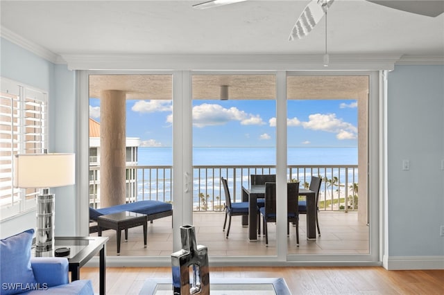 sunroom / solarium with a water view and a healthy amount of sunlight