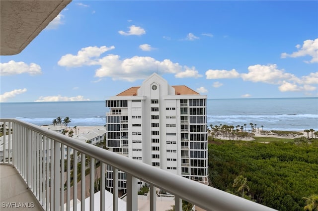 balcony featuring a beach view and a water view