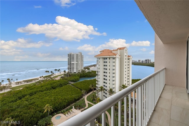 balcony with a water view and a beach view