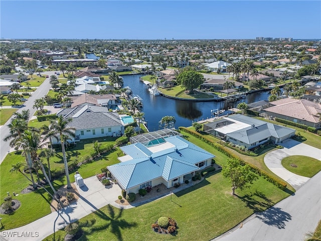 birds eye view of property with a residential view and a water view