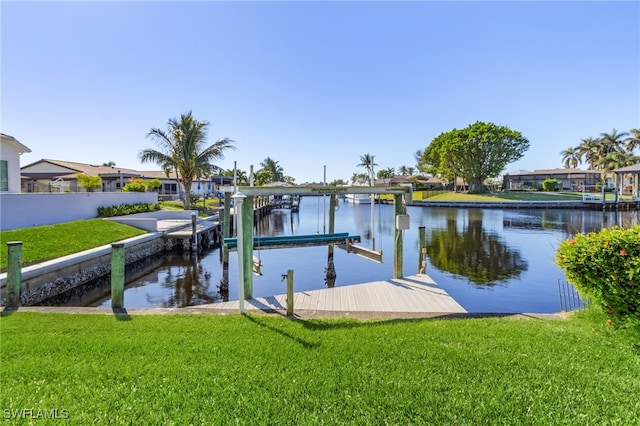 dock area with a yard and a water view