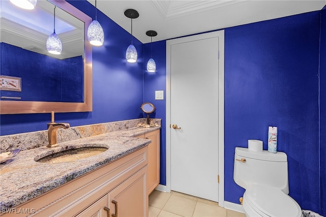 bathroom with tile patterned floors, crown molding, vanity, and toilet