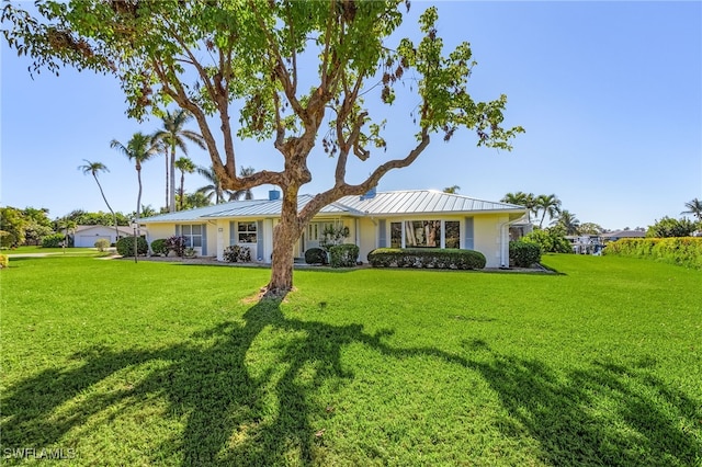 rear view of property with a lawn