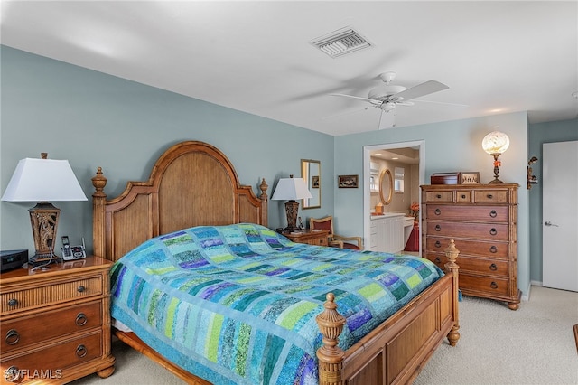 bedroom featuring ceiling fan, light carpet, and ensuite bath