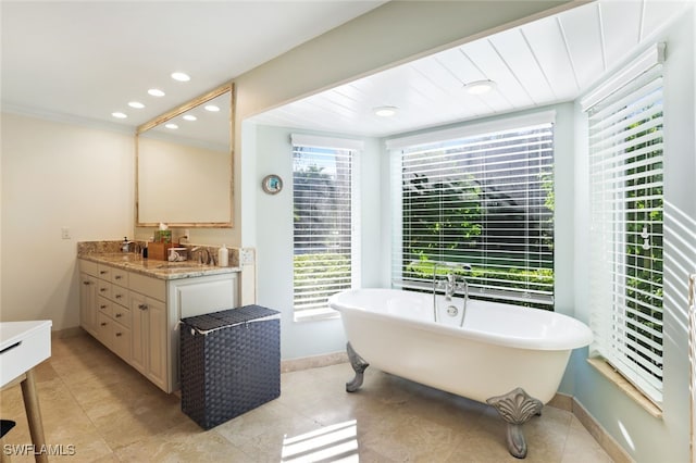 bathroom featuring tile patterned floors, vanity, and a tub to relax in