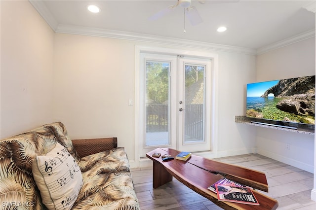 living room with crown molding, light hardwood / wood-style flooring, and ceiling fan