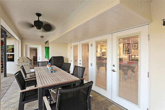 dining area with ceiling fan, french doors, and wood ceiling